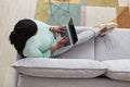 Overweight African American Woman Relaxing at Home with Laptop Royalty Free Stock Photo