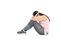 Overweight Asian woman sitting on the floor looking sad isolated on white background