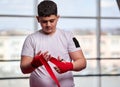 Overweight boxer wrapping his hands