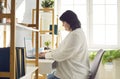 Overweight brunette woman working with laptop in office