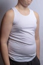 Overweight caucasian teenage boy in a sleeveless top