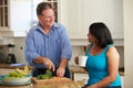 Overweight Couple On Diet Preparing Vegetables In Kitchen Royalty Free Stock Photo