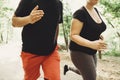 Overweight couple losing weight running together