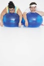 Overweight Couple Resting On Exercise Balls