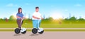 Overweight couple riding self balancing scooter city park obese man woman on electric gyroscooter weight loss concept