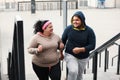 Overweight couple running up stairs together