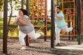 Overweight couple training together on ground