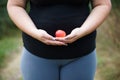 Overweight fat woman with little apple Royalty Free Stock Photo