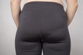 Overweight female buttocks in black leggings closeup Royalty Free Stock Photo