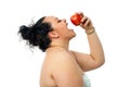 Overweight girl eating red apple. Royalty Free Stock Photo