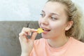 An overweight girl eats potato chips. Junk food. Selective focus