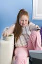 Overweight Girl With Remote Control Eats Sweet Food On Couch Royalty Free Stock Photo