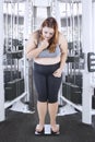 Overweight girl stands on weighing scale Royalty Free Stock Photo