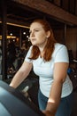 Overweight girl training on treadmill in gym Royalty Free Stock Photo