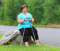 Overweight hiker woman relaxing.