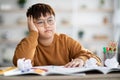 Overweight japanese boy doing school project, got tired