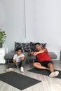 Overweight Latino dad and son celebrate breaking record for time exercising at home to improve their health
