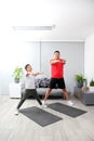 Overweight Latino dad and son exercise at home to lose weight and be healthy to avoid diseases such as diabetes or hypertension