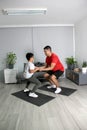 Overweight Latino dad and son exercise at home to lose weight and be healthy to avoid diseases such as diabetes or hypertension