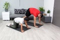 Overweight Latino dad and son exercise at home to lose weight and be healthy to avoid diseases such as diabetes or hypertension