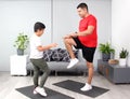 Overweight Latino dad and son exercise at home to lose weight and be healthy to avoid diseases such as diabetes or hypertension