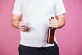 Overweight lazy man with smartphone drinking beer Royalty Free Stock Photo