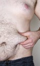 Overweight male pinching his skin Royalty Free Stock Photo