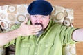 Overweight man in beret blowing kiss