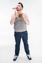 Overweight man biting sausage and holding glass of beer Royalty Free Stock Photo