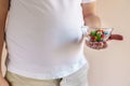 Overweight man eating candies. fattening food Royalty Free Stock Photo