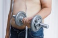 Overweight man exercising by lifting weight with a dumbbell Royalty Free Stock Photo