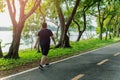 Overweight man exercising walking to burn fat out in the park. Royalty Free Stock Photo