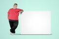 Overweight man leaning on a blank whiteboard Royalty Free Stock Photo