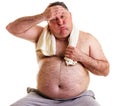 Overweight man resting, tired after training, with hand on forehead