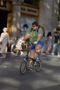 Overweight man riding bicycle on Passeig de GrÃ¯Â¿Â½cia in the Eixample district, busy street in Barcelona, Spain, Europe