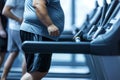 Overweight man runs on treadmill in gym