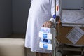 Overweight man stands with a dropper on the background of the bed, equipment in the foreground, patient in the hospital Royalty Free Stock Photo