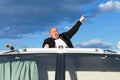 Overweight man in a tuxedo at the helm of a pleasure boat Royalty Free Stock Photo