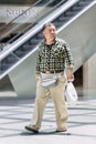 Overweight man walks in Livat Shopping mall, Beijing, China