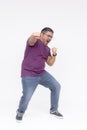 A overweight middle aged guy makes a funny looking punch. Overwhelmed with joy. Full body photo, isolated on a white background