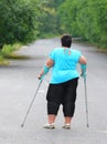 Overweight patient with crutches.