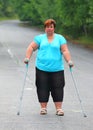 Overweight patient with crutches.