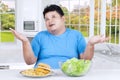 Overweight person thinks to choose meal Royalty Free Stock Photo