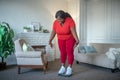 Plus size african american woman checking her weight and looking frustrated Royalty Free Stock Photo