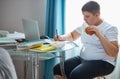 Overweight school boy eat sandwich while doing homework Royalty Free Stock Photo