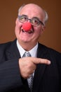 Overweight senior businessman wearing red clown nose Royalty Free Stock Photo