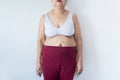 Overweight senior woman pinching her fat body,Cellulite around her belly button,Bloated belly,Healthy lifestyle concept,Copy space Royalty Free Stock Photo