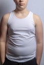 Overweight caucasian teenage boy in a sleeveless top