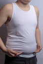 Overweight caucasian teenage boy in a sleeveless top