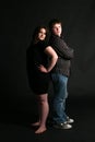 Overweight teenage couple standing back to Royalty Free Stock Photo